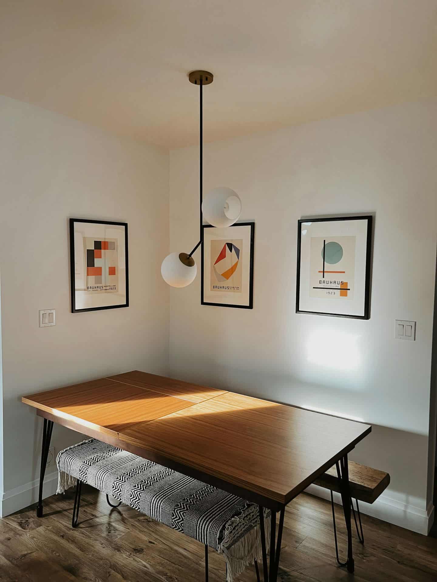 a dining room table with a bench underneath it